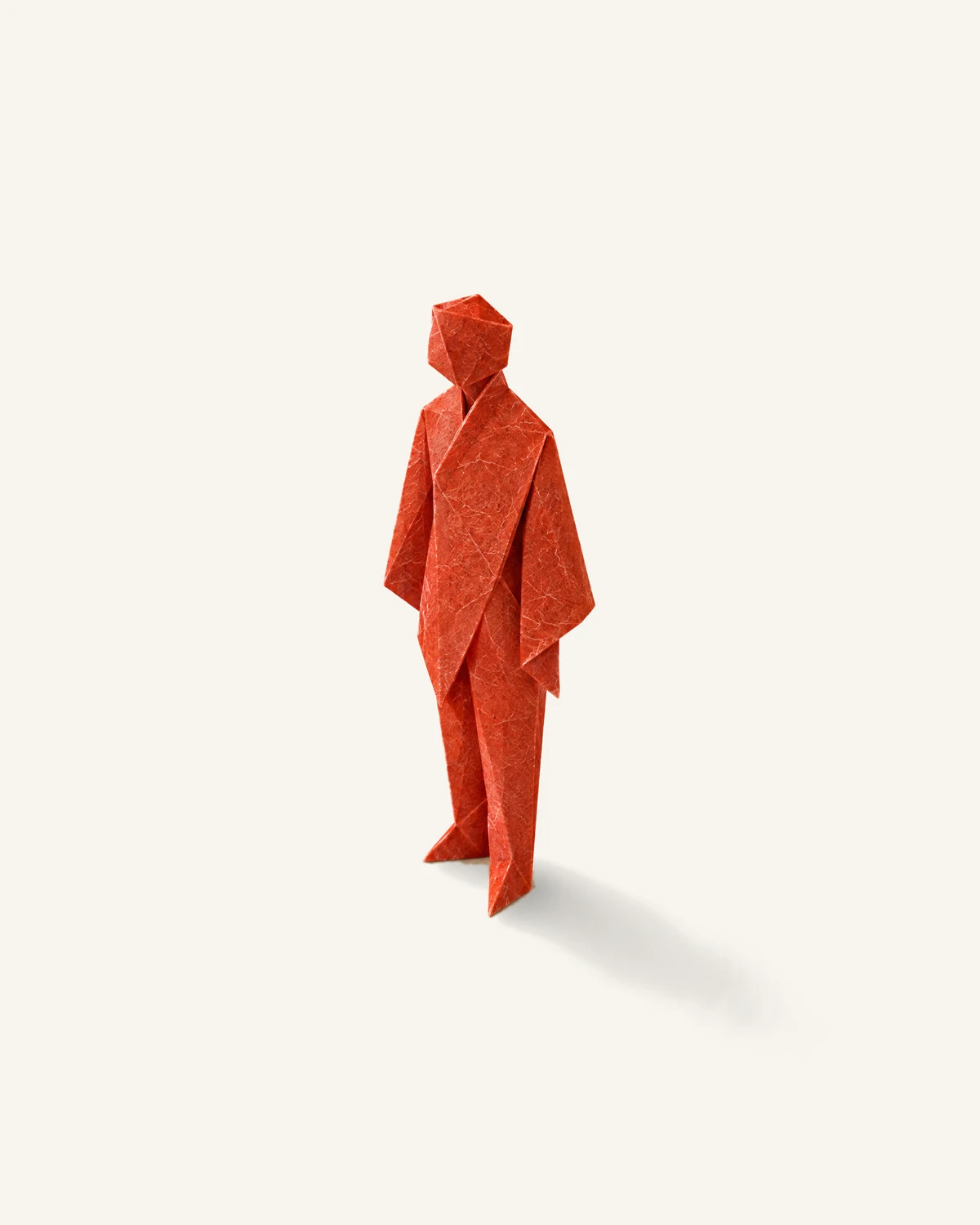 A standing human figure folded from a single sheet of vermilion washi paper, on warm white paper.